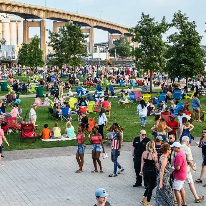 Colorful crowd canalside lawn